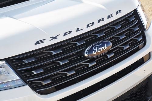 The front end of the 2017 Ford Explorer XLT Sport Appearance Package features a Magnetic Gray grille and nameplate badging across the hood. Preproduction model shown in White Platinum Metallic; available summer 2016.